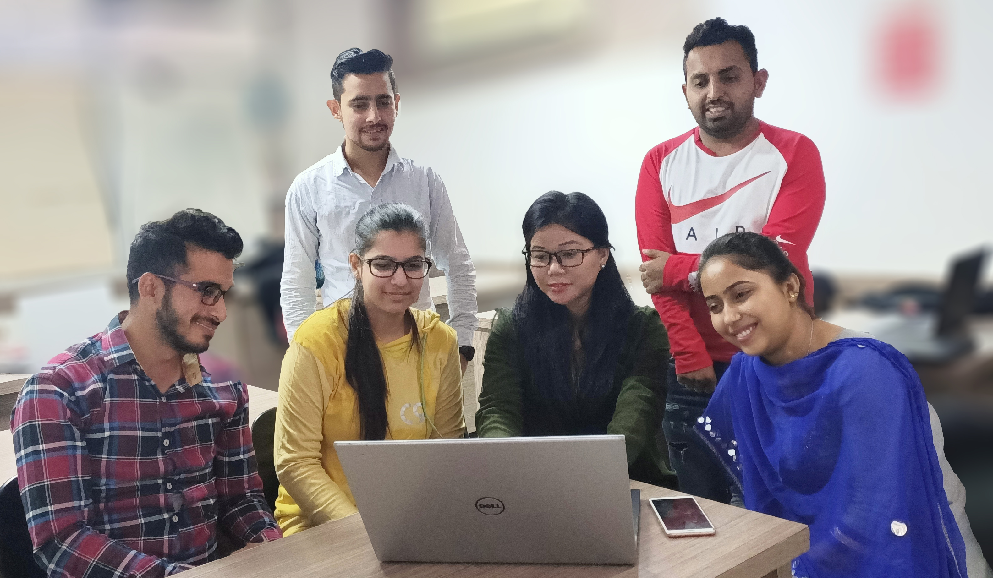 Students doing group project on laptop at Gurukull Institute